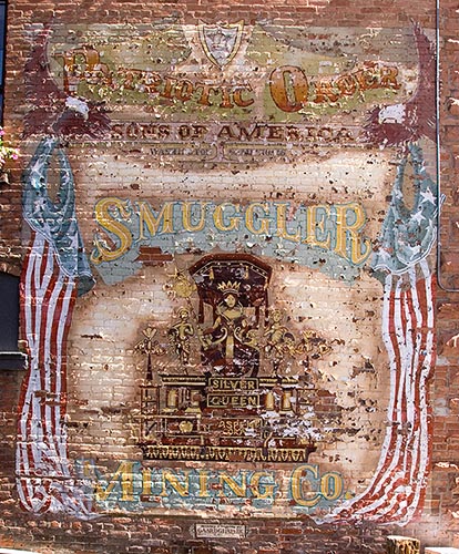 [© Smuggler Mining Company by Judy Hill is described with Color, Warm, Town, Vertical, Historic, Wall, Fine Art, Stock, Beige, White, Reds, Blue, Aspen, Colorado, 2004, Building, Aspen hit 9532 rate ]