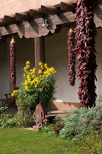 [© Ristas and Flowers by Judy Hill is described with New Mexico, 2005, Spring, Summer, Southwest, Santa Fe, Flowers, Garden, Adobe, Buildings, Stock, Vertical, Beige, Brown, Green, Hot, Neutrals, Peach, Reds, Pink, Warm, Yellows, Chili, Carving, Town, Color, Museum, Flower, Grass, Desert hit 5046 rate ]