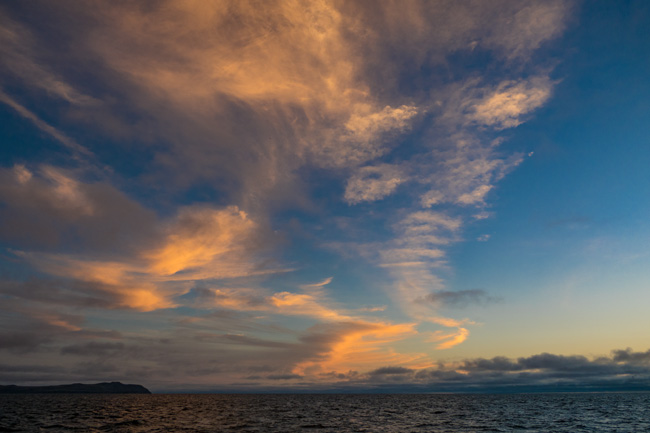 [© Cloud Caligraphy by Judy Hill Lovins is described with Galapagos, Color, Fine Art, Horizontal, Orange, Blue, Sky, Sunset, Sunrise hit 9932 rate ]